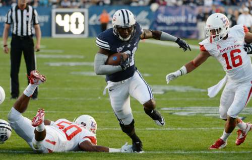 Steve Griffin  |  The Salt Lake Tribune


BYU Cougars running back Jamaal Williams (21) splits the Houston defense on his way to a touchdown during game between BYU and Houston and LaVell Edwards Stadium in Provo, Thursday, September 11, 2014.