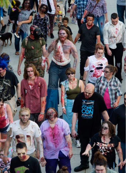 Steve Griffin  |  The Salt Lake Tribune

Zombies make their way through the Gateway in Salt Lake City, Sunday, August 30, 2015 as Comic Con sponsors the 8th annual SLC Zombie Walk. The Zombie Walk is similar to a flash mob as participants followed a designated route that circled the Salt Palace Convention Center and back to the Gateway.