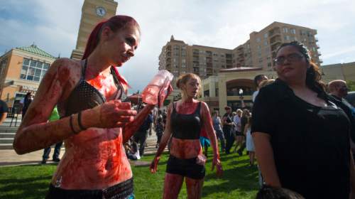 Steve Griffin  |  The Salt Lake Tribune

Zombies make their way through the Gateway in Salt Lake City, Sunday, August 30, 2015 as Salt Lake Comic Con sponsors the 8th annual SLC Zombie Walk. The Zombie Walk is similar to a flash mob as participants followed a designated route that circled the Salt Palace Convention Center and back to the Gateway.