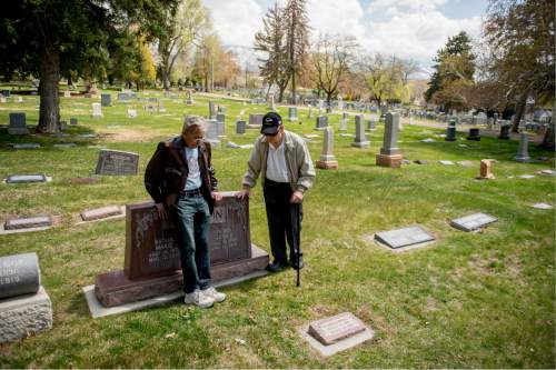 Jeremy Harmon  |  The Salt Lake Tribune
Cousins Merlin Morrison, 80, and Jay Arling Morrison, 84, talk at the gravesite of their grandparents John G. and Marie Morrison in the Salt Lake City Cemetery on April 9, 2015. Merlin is named after his father, who as a 13-year-old boy witnessed his own father, John G., being fatally shot, along with the teenís older brother, Arling. Industrial Workers of the World songwriter Joe Hill was later convicted of the Jan. 10, 1914, murder of John Morrison and executed at the Utah State Prison.