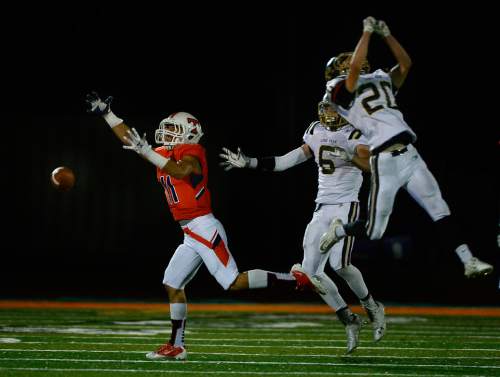 Scott Sommerdorf   |  The Salt Lake Tribune
This pass slips through three pairs of hands as Timpview WR Nejad Arshad can't hold on to the 2nd half pass. Lone Peak beat Timpview 35-14 in Provo, Friday, August 28, 2015.
