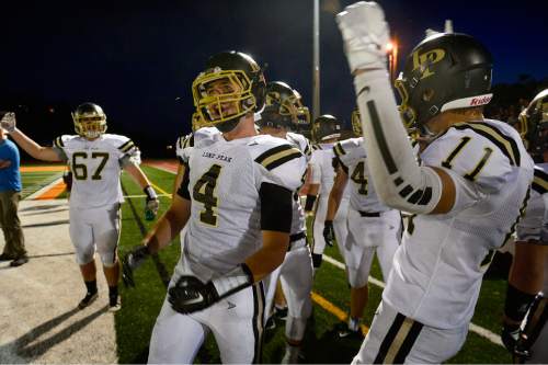 Scott Sommerdorf   |  The Salt Lake Tribune
The Lone Peak sideline celebrates as they build a 28-14 lead over Timpview in the second half. Lone Peak beat Timpview 35-14 in Provo, Friday, August 28, 2015.