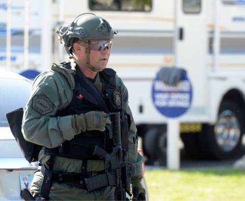 Al Hartmann  |  The Salt Lake Tribune
West Valley City police and SWAT units surround a trailer park near 7000 West and 2600 West where an armed male suspect holds a man hostage Monday, August 31.