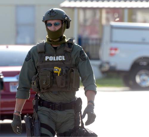 Al Hartmann  |  The Salt Lake Tribune
West Valley City police and SWAT units surround a trailer park near 7000 West and 2600 West where an armed male suspect holds a man hostage Monday, August 31.