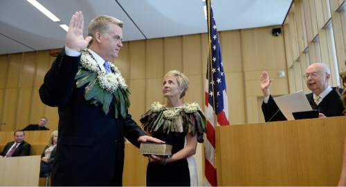 Francisco Kjolseth | The Salt Lake Tribune
John W. Huber is sworn in as U.S. Attorney for Utah by U.S. District Judge Dale A. Kimball who administers the oath at the new Federal Courthouse in Salt Lake City on Monday, Aug. 31, 2015.  John W. Huber and his wife Lori were presented with Tongan flower Lei's made by Sela Tauteoli, in honor of Huber's swearing in.