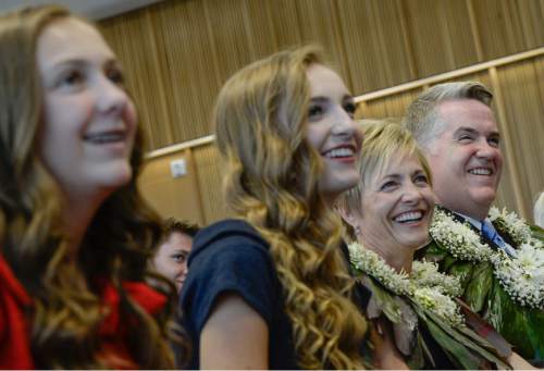 Francisco Kjolseth | The Salt Lake Tribune
John W. Huber, joined by his wife Lori, and daughters Eva, 12, left, and Hannah, 16, laugh as good friend Scott Romney recounts a few stories of working with John before he was sworn in as U.S. Attorney for Utah at the new Federal Courthouse in Salt Lake City on Monday, Aug. 31, 2015.  John W. Huber and his wife Lori were presented with Tongan flower Lei's made by Sela Tauteoli, in honor of Huber's swearing in.