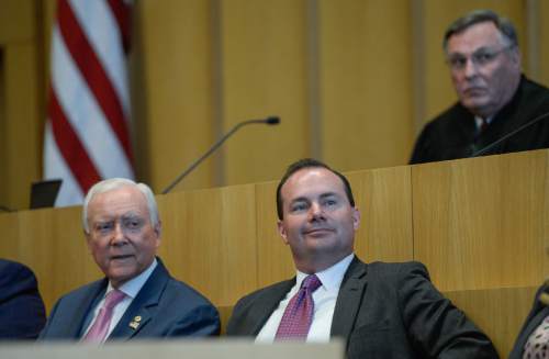 Francisco Kjolseth | The Salt Lake Tribune
Senator's Orrin Hatch, left, and Mike Lee join Magistrate Judge Paul M. Warner, in background as John W. Huber is sworn in as U.S. Attorney for Utah at the new Federal Courthouse in Salt Lake City on Monday, Aug. 31, 2015.  John W. Huber and his wife Lori were presented with Tongan flower Lei's made by Sela Tauteoli, in honor of Huber's swearing in.