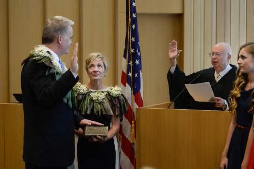 Francisco Kjolseth | The Salt Lake Tribune
John W. Huber is sworn in as U.S. Attorney for Utah as he is joined by his wife Lori while U.S. District Judge Dale A. Kimball administers the oath at the new Federal Courthouse in Salt Lake City on Monday, Aug. 31, 2015.  John W. Huber and his wife Lori were presented with Tongan flower Lei's made by Sela Tauteoli, in honor of Huber's swearing in.