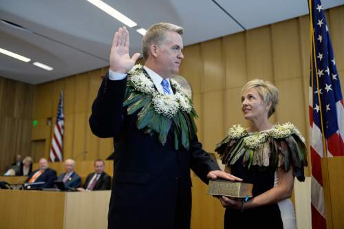 Francisco Kjolseth | The Salt Lake Tribune
John W. Huber is sworn in as U.S. Attorney for Utah as he is joined by his wife Lori while U.S. District Judge Dale A. Kimball administers the oath at the new Federal Courthouse in Salt Lake City on Monday, Aug. 31, 2015.  John W. Huber and his wife Lori were presented with Tongan flower Lei's made by Sela Tauteoli, in honor of Huber's swearing in.