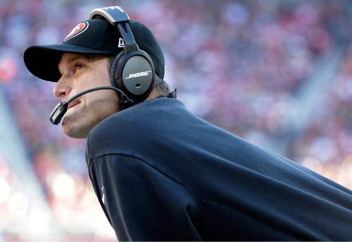 San Francisco 49ers head coach Jim Harbaugh watches from the sideline during the first quarter of an NFL football game against the Arizona Cardinals in Santa Clara, Calif., Sunday, Dec. 28, 2014. (AP Photo/Marcio Jose Sanchez)