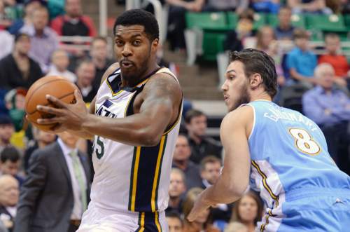 Steve Griffin  |  The Salt Lake Tribune

Utah Jazz forward Derrick Favors (15) spins around Denver Nuggets forward Danilo Gallinari (8) on his way to the basket during first half action in the Jazz versus Nuggets NBA game at EnergySolutions Arena in Salt Lake City, Wednesday, April 1, 2015.