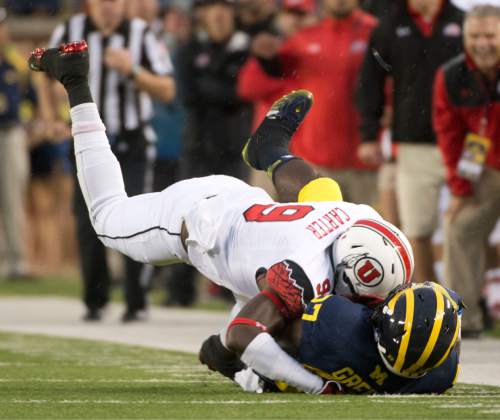 Jeremy Harmon  |  The Salt Lake Tribune

Utah's Tevin Carter (9) tackles Michigan's Derrick Green (27) as the Utes face the Wolverines in Ann Arbor, Saturday, Sept. 20, 2014.