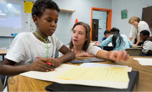Steve Griffin  |  The Salt Lake Tribune

Katie Beerman helps Adnan Osman with a reading assignment during her ninth grade class at the Utah International Charter School in Salt Lake City, Tuesday, September 1, 2015.