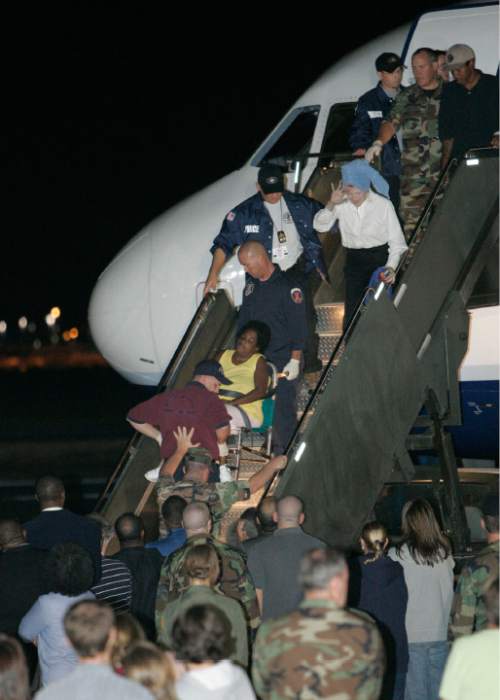 | Tribune File Photo

Evacuees from Hurricane Katrina exit a plane at the Utah Air National Guard on September 4, 2005.
