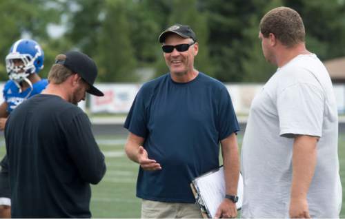 Steve Griffin  |  The Salt Lake Tribune

Bingham High head football coach John Lambourne, center, talks with his assistant coaches before practice on The Bingham High School football field  in South Jordan, Utah on Wednesday, August 26, 2015. Lambourne was named head coach following the retirement of Dave Peck and takes over one of the state's most successful football programs.