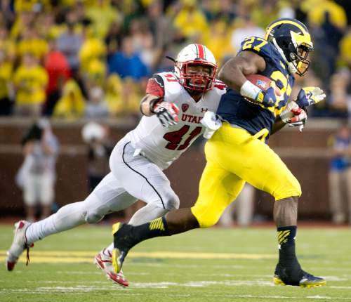 Jeremy Harmon  |  The Salt Lake Tribune

Utah's Jared Norris (41) just misses a tackle on Michigan's Derrick Green (27) as the Utes face the Wolverines in Ann Arbor, Saturday, Sept. 20, 2014.