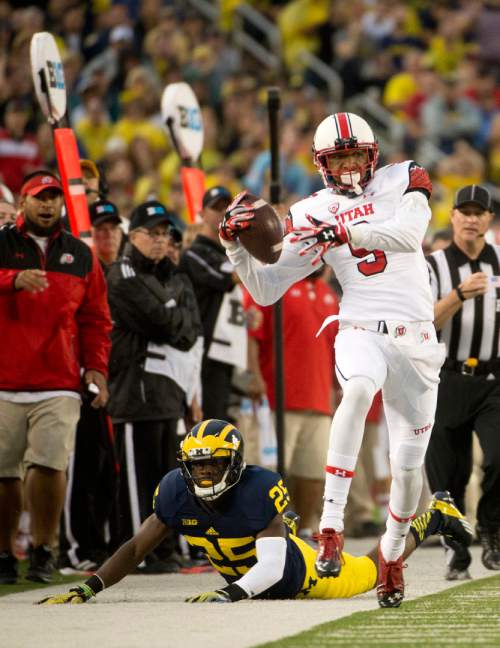 Jeremy Harmon  |  The Salt Lake Tribune

Utah's Tim Patrick (9) is run out of bounds by Michigan's Dymonte Thomas (25) as the Utes face the Wolverines in Ann Arbor, Saturday, Sept. 20, 2014.