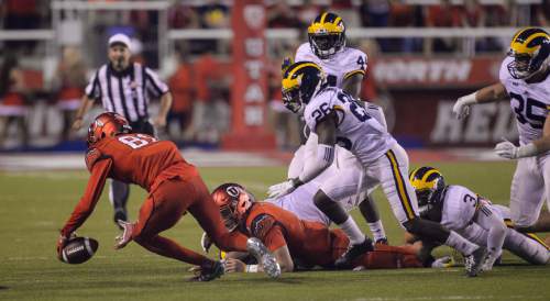 Francisco Kjolseth | The Salt Lake Tribune
Utah tries to regain control of a fumble while battling the Michigan Wolverines in game action at Rice Eccles Stadium on Thursday, Sept. 3, 2015.