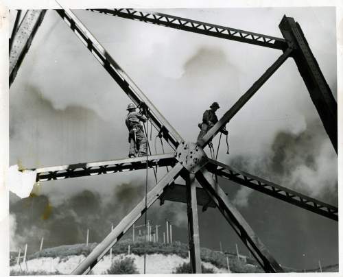 Tribune file photo

The original caption on this 1939 photo says: "Ed Ruben, left, and Ben Conklin, riveters, hoist platforms up to steel star in preparation for work."