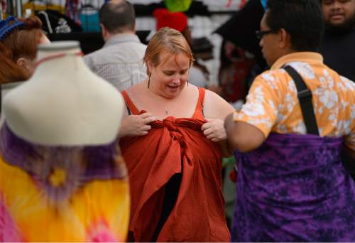 Leah Hogsten  |  The Salt Lake Tribune
Elizabeth Lambie learns how to tie a lava lava from LavaLava Life seller Malaela "Ta" Pauga at Polynesian Days at Thanksgiving Point that showcases the cultures, foods, entertainment and diversities of the peoples of the Polynesian islands, September 5, 2015.
