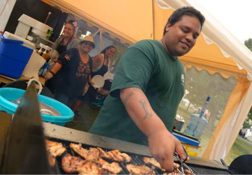Leah Hogsten  |  The Salt Lake Tribune
"It's a definite way for us to connect to our homeland," said Kavika Kauo, flipping Teriyaki chicken at his family's food stand at Polynesian Days at Thanksgiving Point that showcases the cultures, foods, entertainment and diversities of the peoples of the Polynesian islands, September 5, 2015.