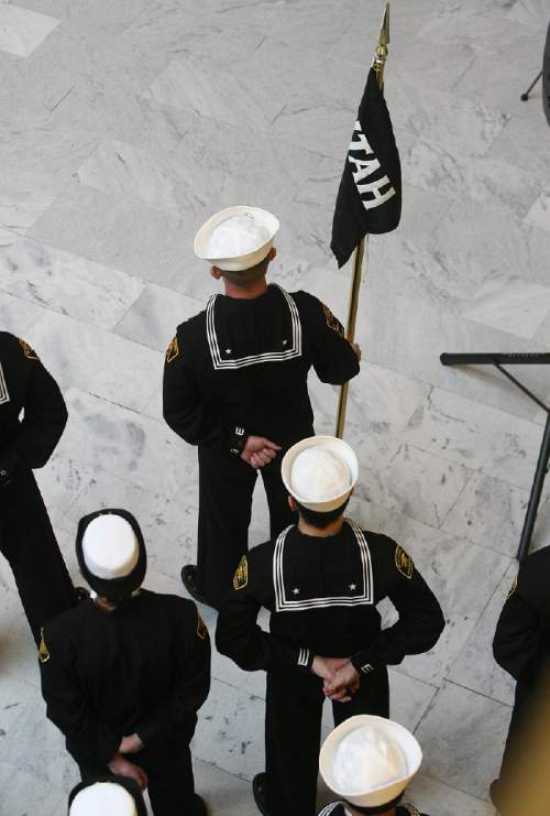 Scott Sommerdorf   |  The Salt Lake Tribune
In this Dec. 7, 2013, photo, cadets stand with the pennant that represents their newly commissioned group name. The Great Salt Lake Division of the Naval Sea Cadet Corps was recommissioned as the NSCC Battleship Utah (BB-31).