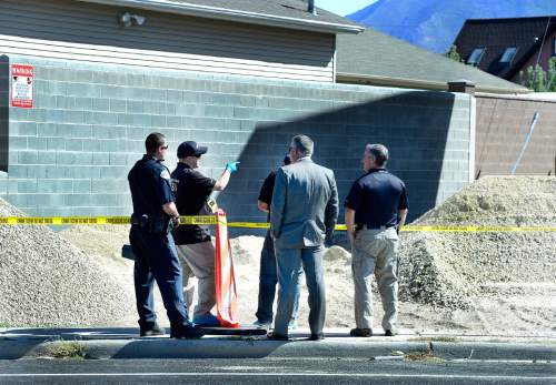 Scott Sommerdorf   |  The Salt Lake Tribune
Police investigate the scene of a homicide at a new home construction site at 527 E. Vine Street in Murray, Sunday, September 6, 2015.