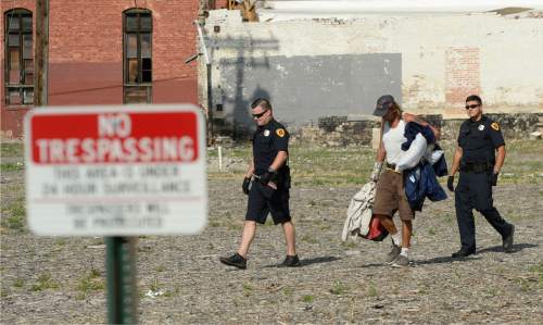 Al Hartmann  |  The Salt Lake Tribune
Salt Lake Police escort a homeless man with his camping gear across a lot posted no tresspassing at 500 W. and 350 S.  It's an area where homeless are camping out on the 500 West Commons just west of the Rio Grande Depot.
