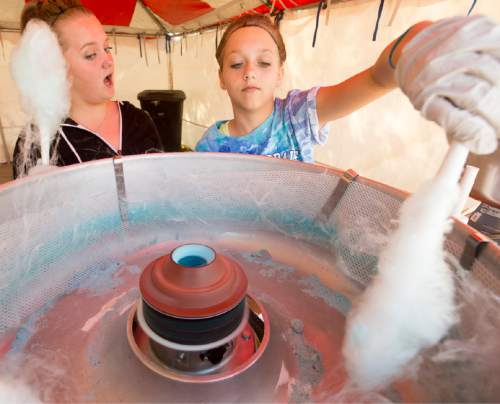 Rick Egan  |  The Salt Lake Tribune

Sisters Katie, 15, and Cassidy Carr,  13, work the cotton candy booth at the 15th Annual Labor Day Picnic, 
in Magna Copper Park,  Monday, September 7, 2015.