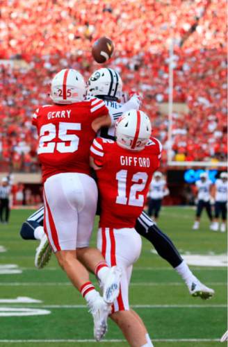 BYU wide receiver Mitch Mathews (10) catches the game winning touchdown in front of Nebraska safety Nate Gerry (25) and linebacker Luke Gifford (12) during the second half of an NCAA college football game in Lincoln, Neb., Saturday, Sept. 5, 2015. Brigham Young won 33-28. (AP Photo/Nati Harnik)