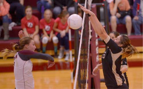 Leah Hogsten  |  The Salt Lake Tribune
Morgan's Jaiden Farr can't top the defense of Lone Peak's Ally Anderson. Morgan High School girls volleyball hosts Lone Peak High, September 8, 2015.