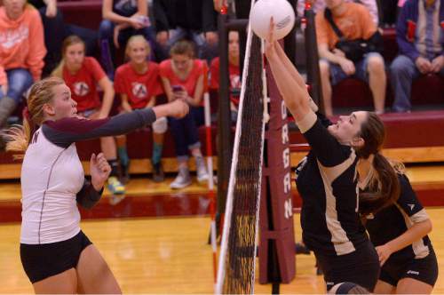 Leah Hogsten  |  The Salt Lake Tribune
Morgan's Aubrey Sanders tries to get a point over on Lone Peak's Makayla Pollard. Morgan High School girls volleyball hosts Lone Peak High, September 8, 2015.