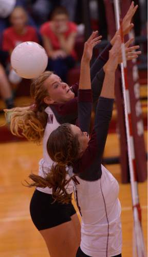 Leah Hogsten  |  The Salt Lake Tribune
Morgan's Aubrey Saunders and Maddie Schenk try for a block. Morgan High School girls volleyball hosts Lone Peak High, September 8, 2015.