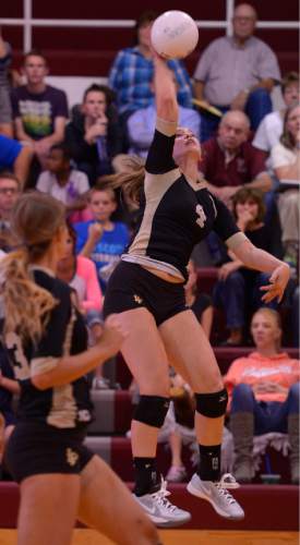 Leah Hogsten  |  The Salt Lake Tribune
Lone Peak's Kacie Huntsman slams a hit across the net. Morgan High School girls volleyball hosts Lone Peak High, September 8, 2015.