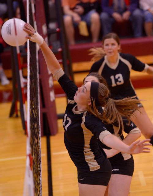 Leah Hogsten  |  The Salt Lake Tribune
Lone Peak's Katelyn Erickson pushes the ball over the net. Morgan High School girls volleyball hosts Lone Peak High, September 8, 2015.