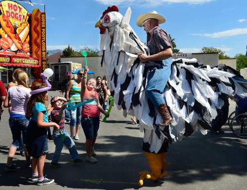 Scott Sommerdorf   |  The Salt Lake Tribune
Young fair visitors joust with "Salt and Pepper" a giant chicken, during the final day of the Utah State Fair, Sunday, Sept. 14, 2014.