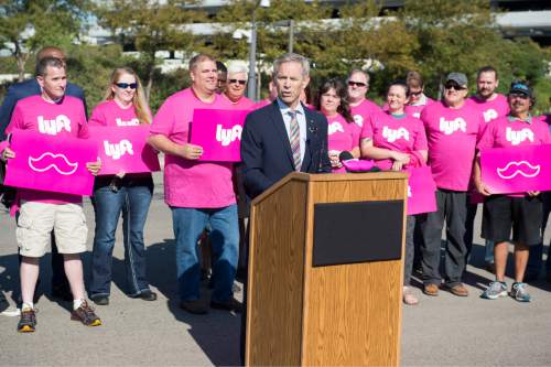 Rick Egan  |  The Salt Lake Tribune

Mayor Ralph Becker, surrounded by Lyft drivers, announces changes to the City's airport ground transportation options at Salt Lake City International Airport, Thursday, September 10, 2015.