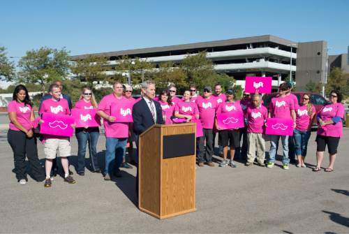 Rick Egan  |  The Salt Lake Tribune

Mayor Ralph Becker, surrounded by Lyft drivers, announces changes to the City's airport ground transportation options at Salt Lake City International Airport, Thursday, September 10, 2015.