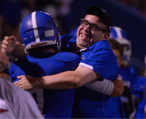 Leah Hogsten  |  The Salt Lake Tribune
Bingham's Brayden Cosper is bear-hugged on the sidelines after his two touchdowns in the final minutes of the game. Bishop Gorman defeated Bingham 38-20. Nationally No. 7-ranked Bingham High School hosted No. 1-ranked Bishop Gorman High School from Nevada, September 4, 2015.
