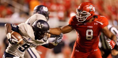 Trent Nelson  |  The Salt Lake Tribune

Utah State Aggies wide receiver Bruce Natson (9) is chased down by Utah Utes defensive end Nate Orchard (8) as the University of Utah hosts Utah State, college football Thursday, August 29, 2013 at Rice-Eccles Stadium in Salt Lake City.