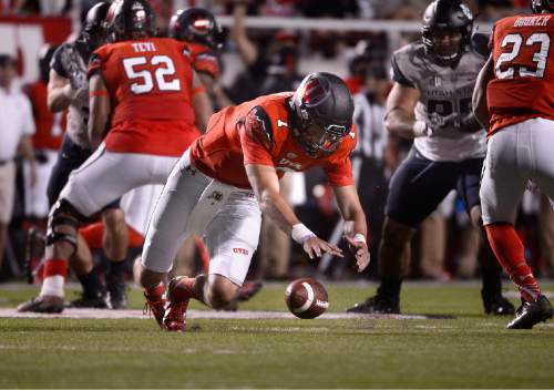Scott Sommerdorf   |  The Salt Lake Tribune
Utah QB Travis Wilson drops to collect a fumbled snap during first half play. Utah and Utah State were tied 14-14 at the half at Rice-Eccles, Friday, September 11, 2015.