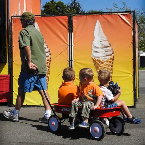 Trent Nelson  |  The Salt Lake Tribune
A wagonload of children eyes an ice cream stand at the Utah State Fair in Salt Lake City on Thursday.