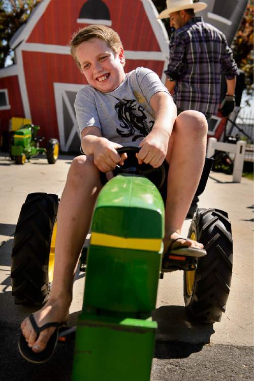 Trent Nelson  |  The Salt Lake Tribune
Canon Hadfield digs deep to reach the finish line of the kids tractor pull at the Utah State Fair in Salt Lake City, Thursday September 10, 2015.