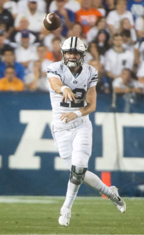 Rick Egan  |  The Salt Lake Tribune

Brigham Young Cougars quarterback Tanner Mangum (12) looks for an open man, in college football action, BYU vs. Boise State at Lavell Edwards Stadium, Friday, August 21, 2015.