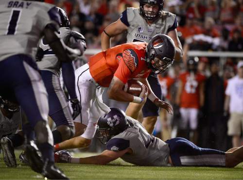 Scott Sommerdorf   |  The Salt Lake Tribune
Utah QB Travis Wilson gains 3 yards to the USU 4 on this running play during second quarter play. After this play, he came out of the game injured. Utah and Utah State were tied 14-14 at the half at Rice-Eccles, Friday, September 11, 2015.