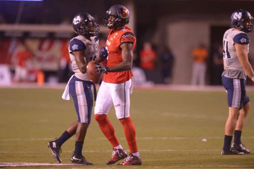 Leah Hogsten  |  The Salt Lake Tribune
Utah State Aggies cornerback Jalen Davis (13) jaws in fun with Utah Utes wide receiver Kenneth Scott (2). University of Utah is tied with Utah State 14-14 at halftime at Rice-Eccles Stadium, Friday, September 11, 2015.