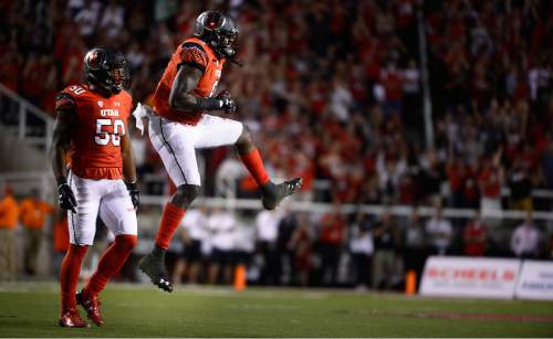 Scott Sommerdorf   |  The Salt Lake Tribune
Utah DE Pita Taumoepenu, left, celebrates and Utah DB Jason Thompson (3) jumps after the defense recovered a USU fumble during 4th quarter play. Utah beat Utah State 24-14 at Rice-Eccles, Friday, September 11, 2015.