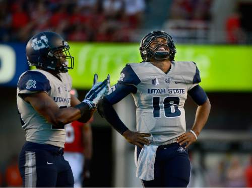 Scott Sommerdorf   |  The Salt Lake Tribune
USU QB Chuckie Keeton grimaces after he was roughed by a Utah player. It resulted in a 15 yard penalty and the drive resulted in a USU TD. Utah and Utah State were tied 14-14 at the half at Rice-Eccles, Friday, September 11, 2015.