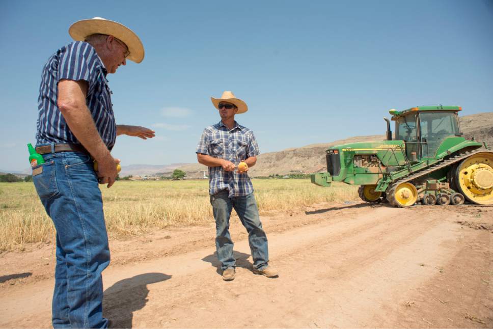 Rick Egan  |  The Salt Lake Tribune

Local farmer John Wadsworth (left) chats with  Derek Spendlove, as he takes  break form plowing one of the fields on Wadsworth's farm in Hurricane, Thursday, August 20, 2015.