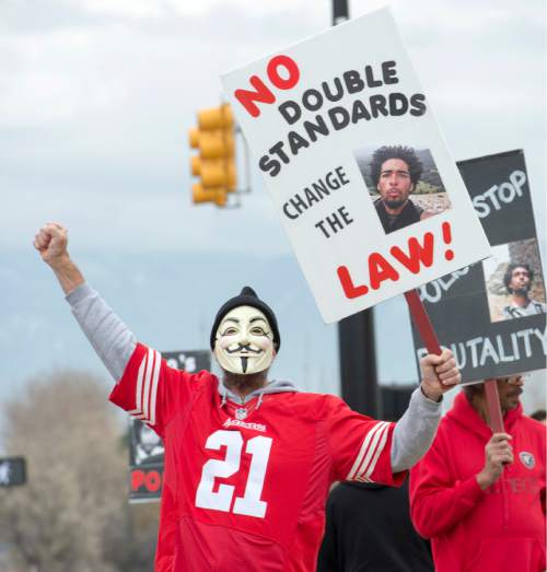Rick Egan  |  The Salt Lake Tribune

Keven Irons chants behind a mask, during a rally in Saratoga Springs, for Darrien Hunt, who was fatally shot by two Saratoga Springs police officers on Sept. 10, 2014, after allegedly swinging a samurai-type sword at the officers.Friday, November 14, 2014